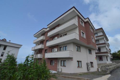 an apartment building with red and white at Konaklar Apart Premium in Trabzon