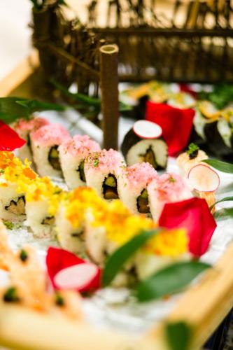 a platter of sushi on a table with at Beijing Xixi Friendship Hotel nearby Xidan Shopping Street, Tian'An Men Square, Forbidden City, Houhai & Jingshan Park in Beijing