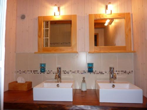 two sinks in a bathroom with two mirrors at La Bergerie du Plateau in Cros-de-Géorand