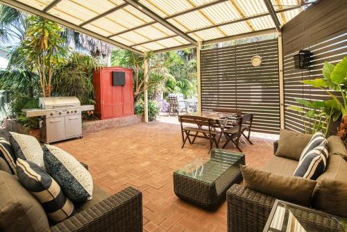a patio with a couch and a table with a stove at Beach Retreat on Kent- Bikes, Large Backyard, Gas BBQ in Busselton