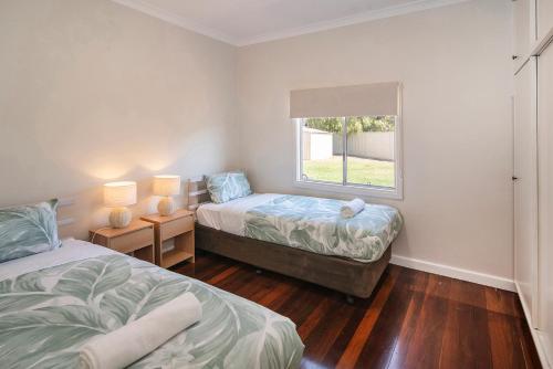 a bedroom with two beds and a window at Beach Retreat on Kent- Bikes, Large Backyard, Gas BBQ in Busselton