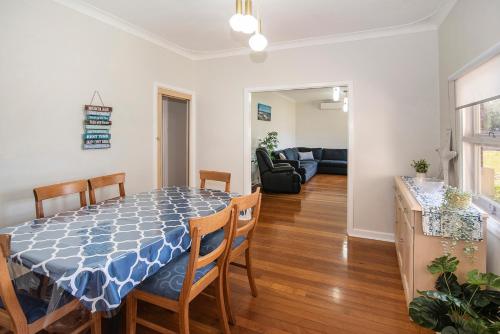 a dining room and living room with a table and chairs at Beach Retreat on Kent- Bikes, Large Backyard, Gas BBQ in Busselton