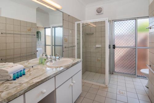 a bathroom with a sink and a shower at Beach Retreat on Kent- Bikes, Large Backyard, Gas BBQ in Busselton
