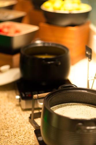 a stove top with pots and pans on a counter at Beijing Xixi Friendship Hotel nearby Xidan Shopping Street, Tian'An Men Square, Forbidden City, Houhai & Jingshan Park in Beijing