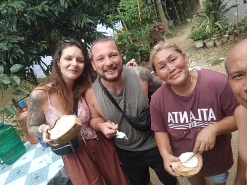 a group of people posing for a picture with food at Brent's Tourist Inn in San Vicente