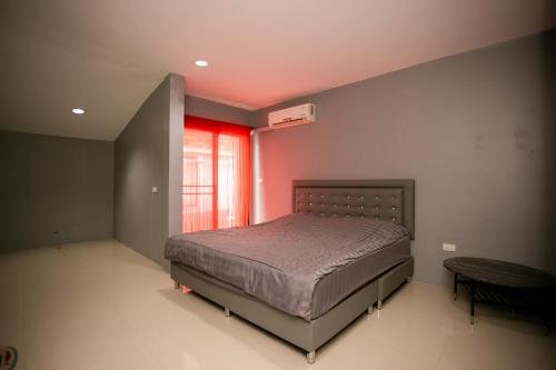 a bedroom with a bed and a red ceiling at Rage Fight Academy in Pattaya South