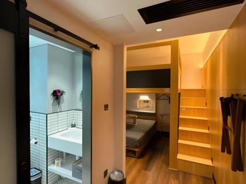 a bathroom with a sink and a bed in a room at Harbour Bay Hotel in Hong Kong