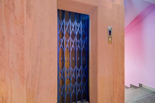 a blue door with a geometric design on a wall at Super Collection O Victoria Memorial Metro Station Formerly Shanthaa Residency in Surūrnagar