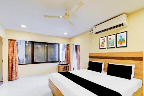 a bedroom with a large bed and a window at Super Collection O Victoria Memorial Metro Station Formerly Shanthaa Residency in Surūrnagar