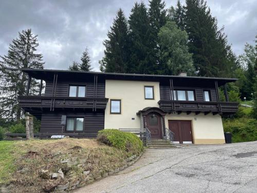 a house with a black and white at House Egger - Top 202 in Bad Kleinkirchheim