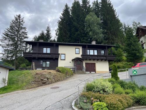 a house on a hill with a driveway at House Egger - Top 202 in Bad Kleinkirchheim
