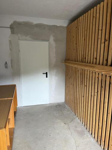 a room with a white door and wooden walls at House Egger - Top 202 in Bad Kleinkirchheim