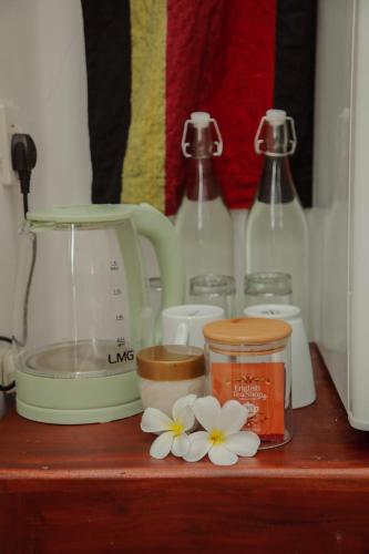 a counter with a blender and flowers on it at Villa Gaetano Unawatuna in Unawatuna