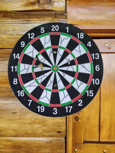 a dart board is hanging on a wooden wall at Cabaña doña Alicia in El Copey