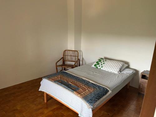 a small bedroom with a bed and a chair at Casa Con Vista Panoramica a Cerreto di Cagli - Animali Ammessi in Pianello