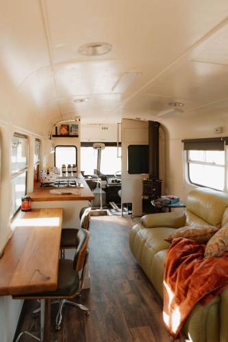 a living room and kitchen in an rv at R&R Bus Retreat in Wellington Mills