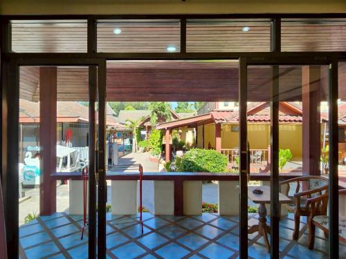 a room with a view of a patio with a table and chairs at Island View Bungalows in Choeng Mon Beach
