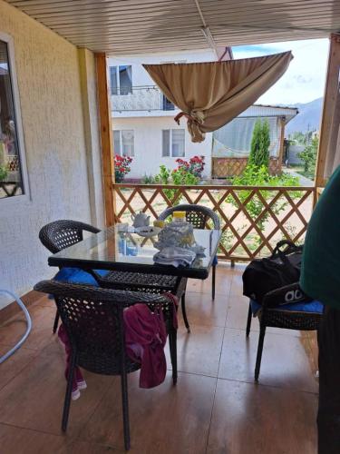 a patio with a table and chairs and an umbrella at Ысык-Кол Чок-Тал in Chok-Tal