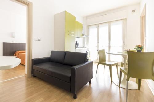 a living room with a couch and a table at Hotel Sharing in Turin