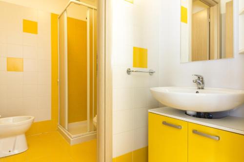 a bathroom with a sink and a shower at Hotel Sharing in Turin
