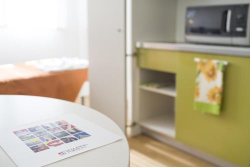 a table with a microwave and a refrigerator at Hotel Sharing in Turin