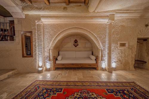 a living room with a couch in a room with a rug at Zara Cave Hotel in Goreme