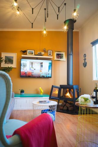 a living room with a fireplace and a tv at MP Beach Club in Tootgarook