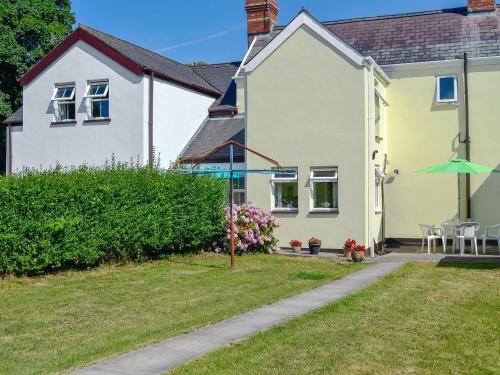 a house with a garden and an umbrella at Hazeldene in Bishopston