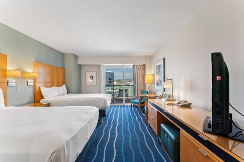 a hotel room with two beds and a flat screen tv at Ala Moana Hotel Sleeps 4 near beach in Honolulu