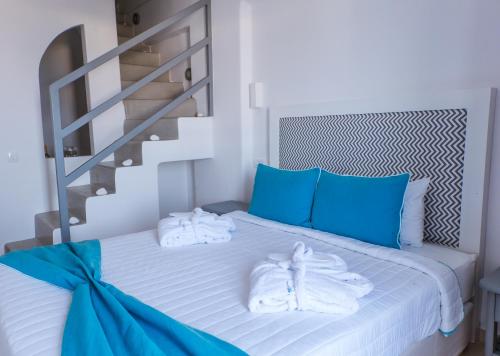 a bedroom with a bed with towels on it at Blue Waves Suites & Apartments in Kamari