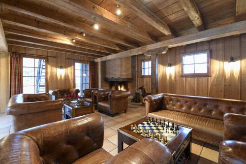 a living room with leather couches and a chess board at Hofgut Albführen in Dettighofen