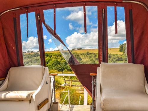 two chairs in front of a window with a view at The Rose in Rhondda