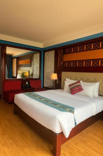 a bedroom with a large bed and a red couch at Sapa Elegance Hotel in Sa Pa