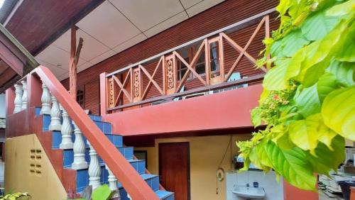 a house with a colorful staircase in front of it at Island View Bungalows in Choeng Mon Beach
