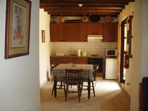 a kitchen with a table and chairs in a room at Kleanthis House in Tochni