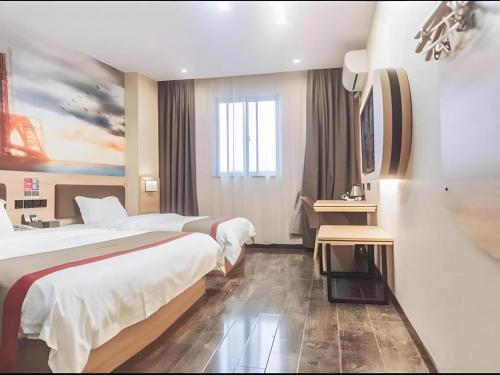 a hotel room with two beds and a window at Thank Inn Hotel Anhui Fuyang Funan County Yunhe Dong Road in Funan