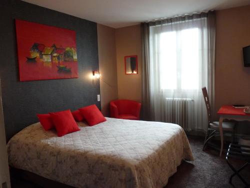 a bedroom with a bed with red pillows and a window at Hôtel Patton in Avranches