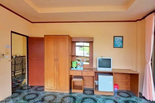 a room with a desk with a television and a window at Island View Bungalows in Choeng Mon Beach