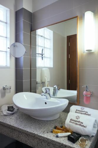 a bathroom with a sink and a mirror at Alexandros Boutique Hotel in Nafplio