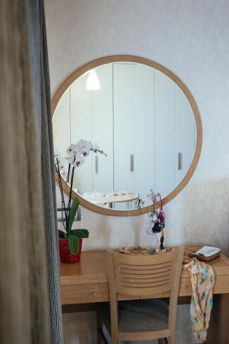a room with a desk with a mirror and a chair at Alexandros Boutique Hotel in Nafplio