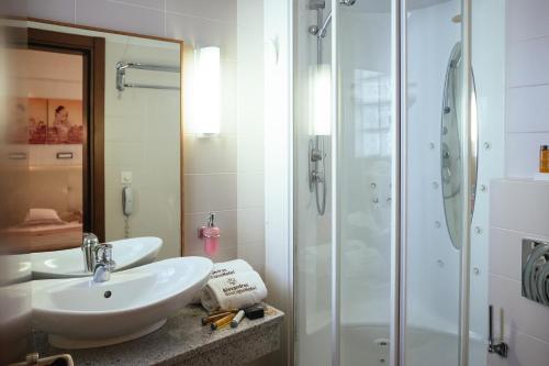 a bathroom with a sink and a shower at Alexandros Boutique Hotel in Nafplio