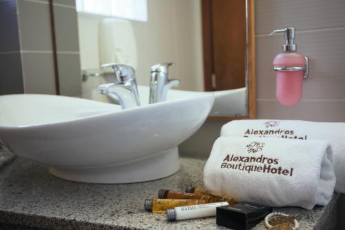 a bathroom counter with a sink and a towel at Alexandros Boutique Hotel in Nafplio