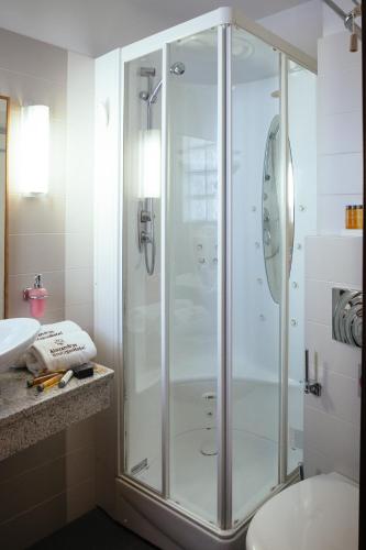 a shower in a bathroom with a toilet and a sink at Alexandros Boutique Hotel in Nafplio
