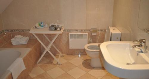 y baño con lavabo, aseo y bañera. en Onsemhoeve, en Dilbeek