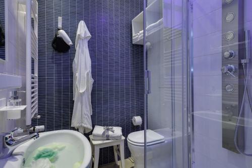 a bathroom with a sink and a toilet and a shower at Dreamsrome Suites in Rome
