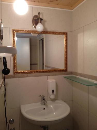 a bathroom with a sink and a mirror at Le dimore Al Vecchio Teatro in Ortona