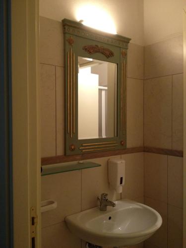 a bathroom with a sink and a mirror at Le dimore Al Vecchio Teatro in Ortona
