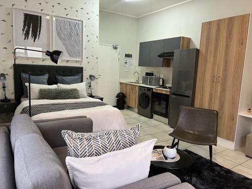 a living room with a bed and a couch at The Lagoon in Pretoria