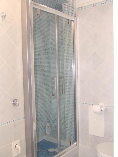 a shower with a glass door in a bathroom at La Terrazza sul Mare in Ascea