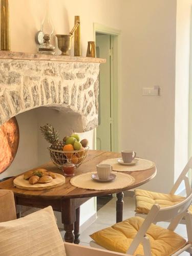 a dining room table with a bowl of fruit on it at ALEMINAS House 1 in Symi